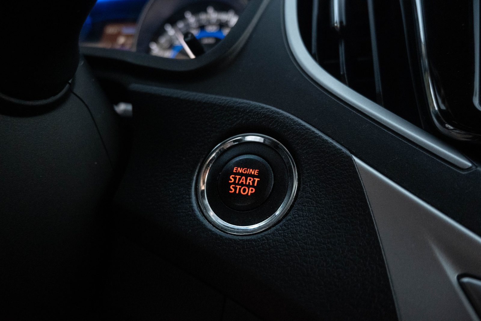 A car dashboard ENGINE START STOP push-to-start button